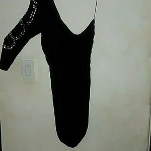 A black dress with gems on one arm